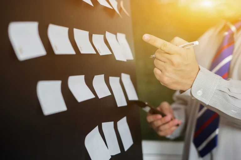 two lawyers at sand law getting evidence together on whiteboard