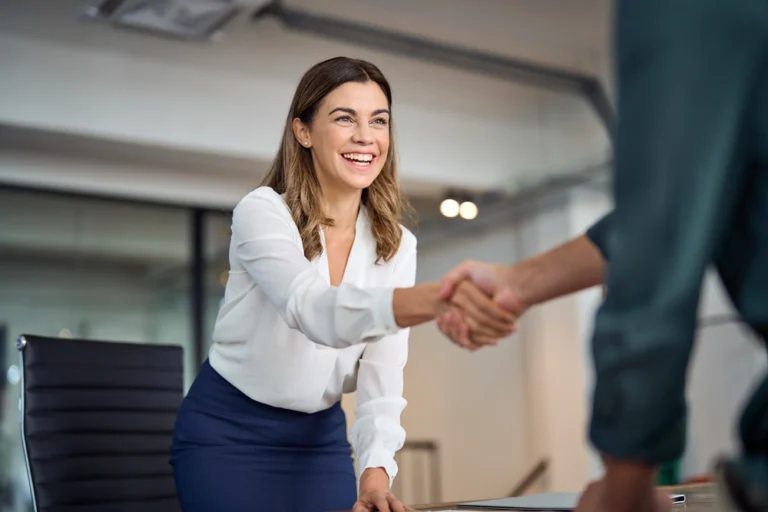 woman shaking an applicants hand at sand law for a job interview
